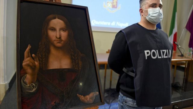 Image shows a police officer stood next to the recovered painting